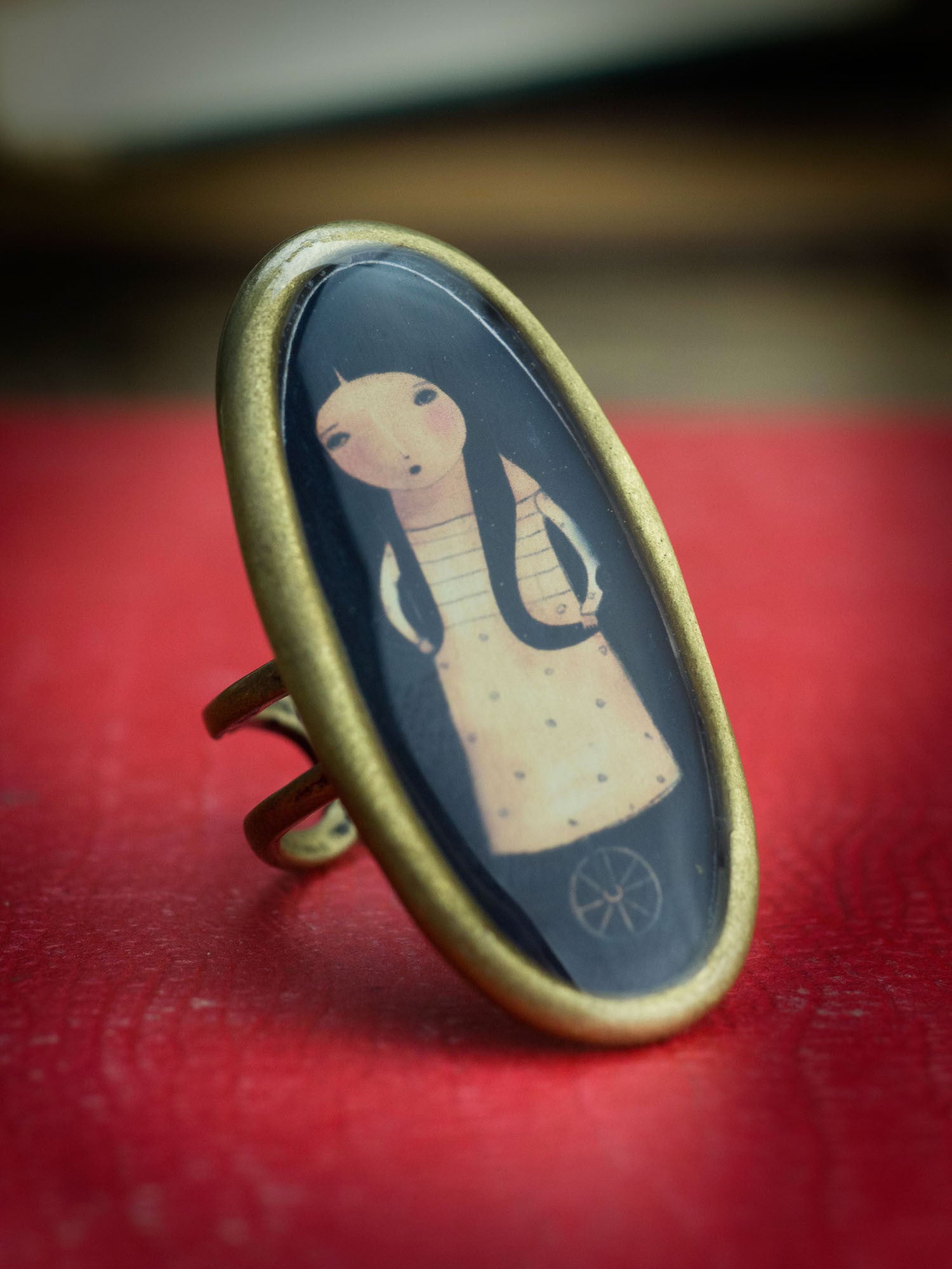 Handmade Ring by Danita Art. A surreal painting of a girl in unicycle wheels make this piece a one of a kind work of wearable art.