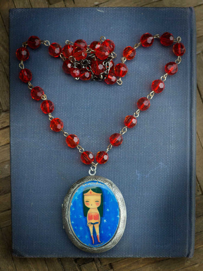 Danita creates handmade jewelry using her original art, just like this Wonder Woman faceted glass chain with locket