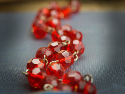 Danita used red faceted glass beads strung by hand to create a beautiful Wonder Woman necklace