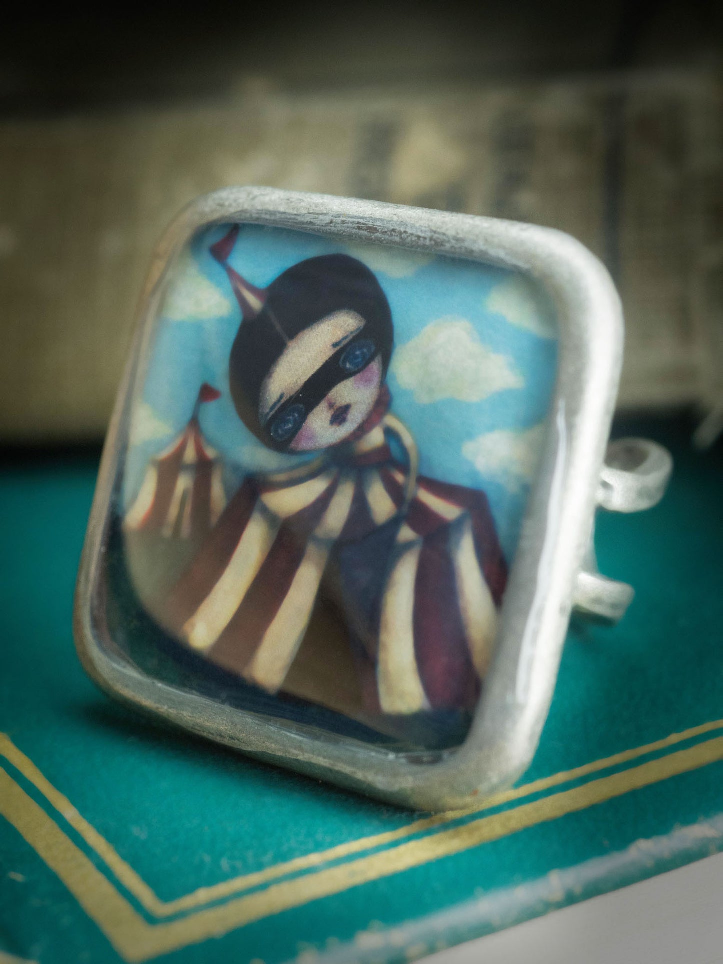 Danita creates beautiful one of a kind pieces of handcrafted jewelry like this square ring with a surreal circus image from Danita.
