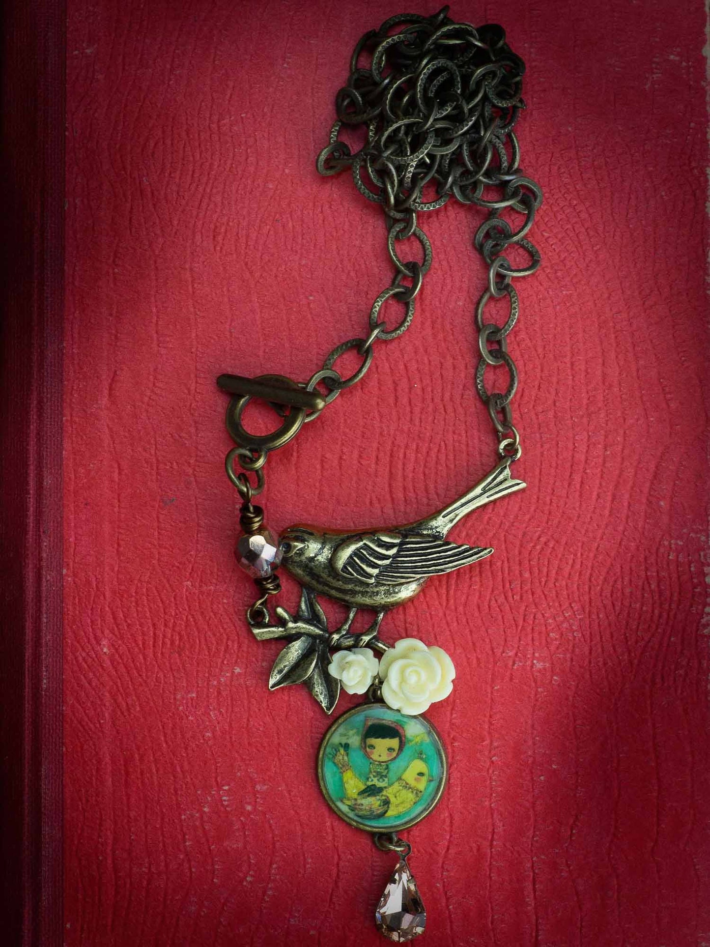 Danita original jewelry necklace wearable art with a metal bird charm and yellow roses