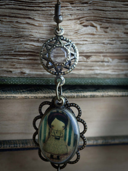 Original jewelry is created by Danita with her whimsical and surreal mixed media images