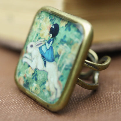 Alice riding the white rabbit in Wonderland square ring, Jewelry by Danita Art