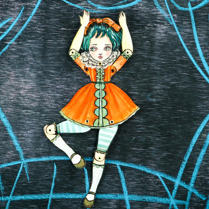 A original watercolor painting that is also a dress up paper art doll. Danita painted a girl, cut her and assembled it as a posable and articulated doll.
