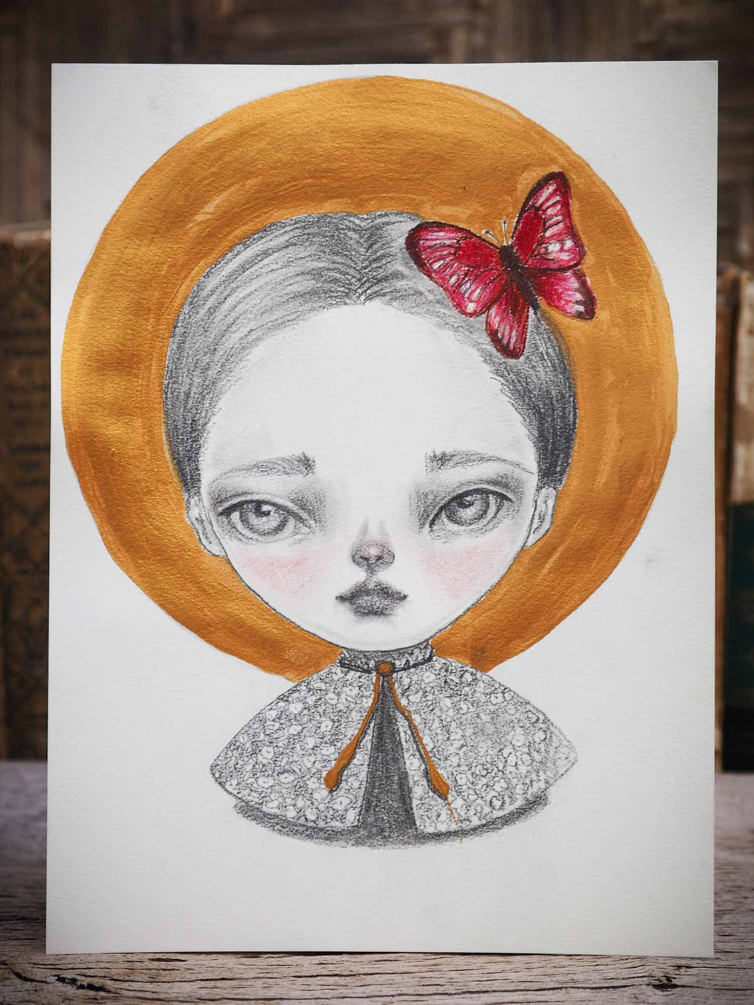 Original mixed media illustration in Pencil, watercolor, gouache and ink by Danita Art. A beautiful girl with deep mesmerizing and expressive eyes has a red butterfly perched on her head like a brooch.