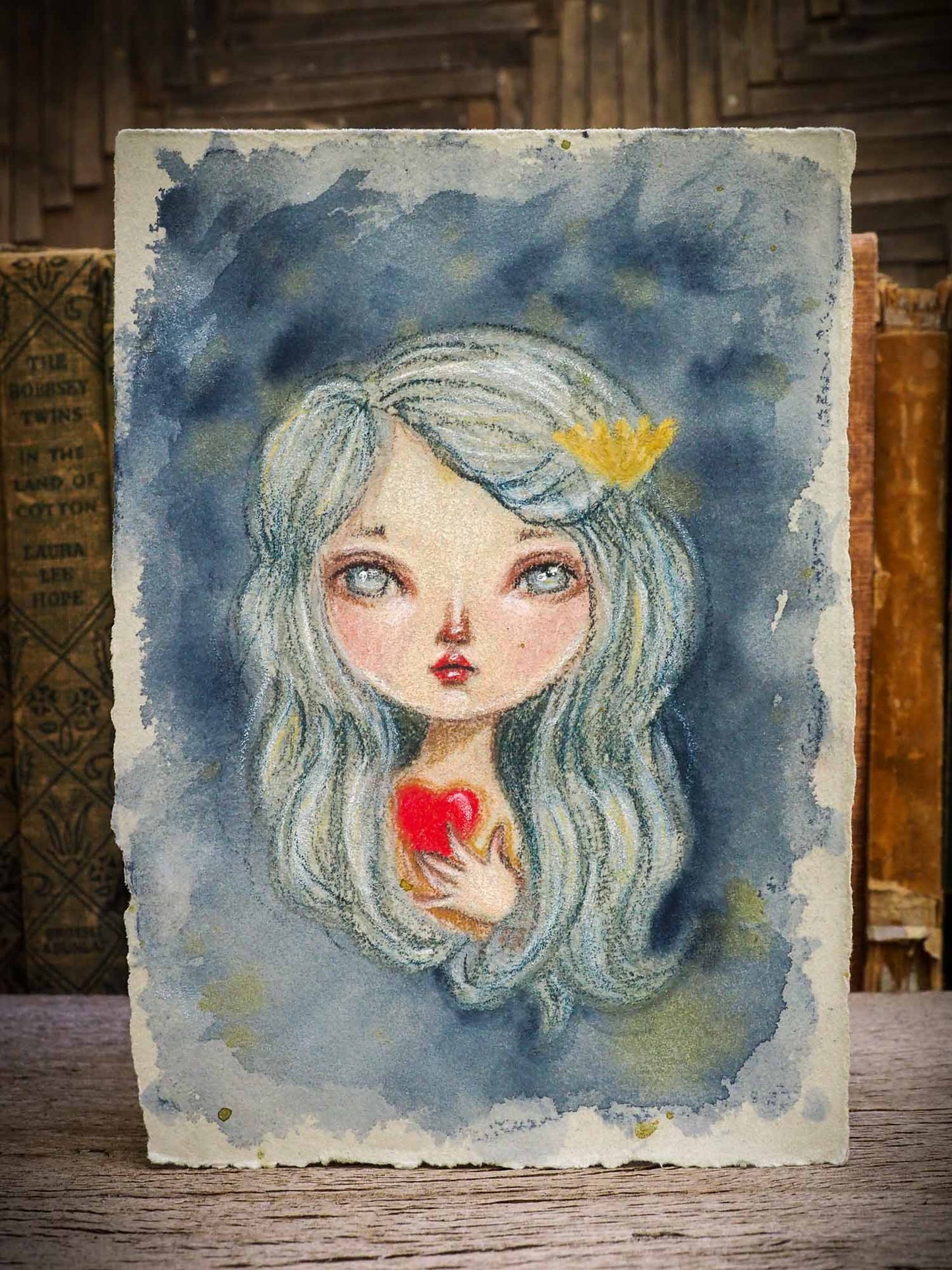 Original Mermaid color pencil and watercolor illustration on hand made paper by Danita Art. A beautiful drawing in colored pencil features fantasy art mermaid and siren with a red heart in her hands by Danita Art.