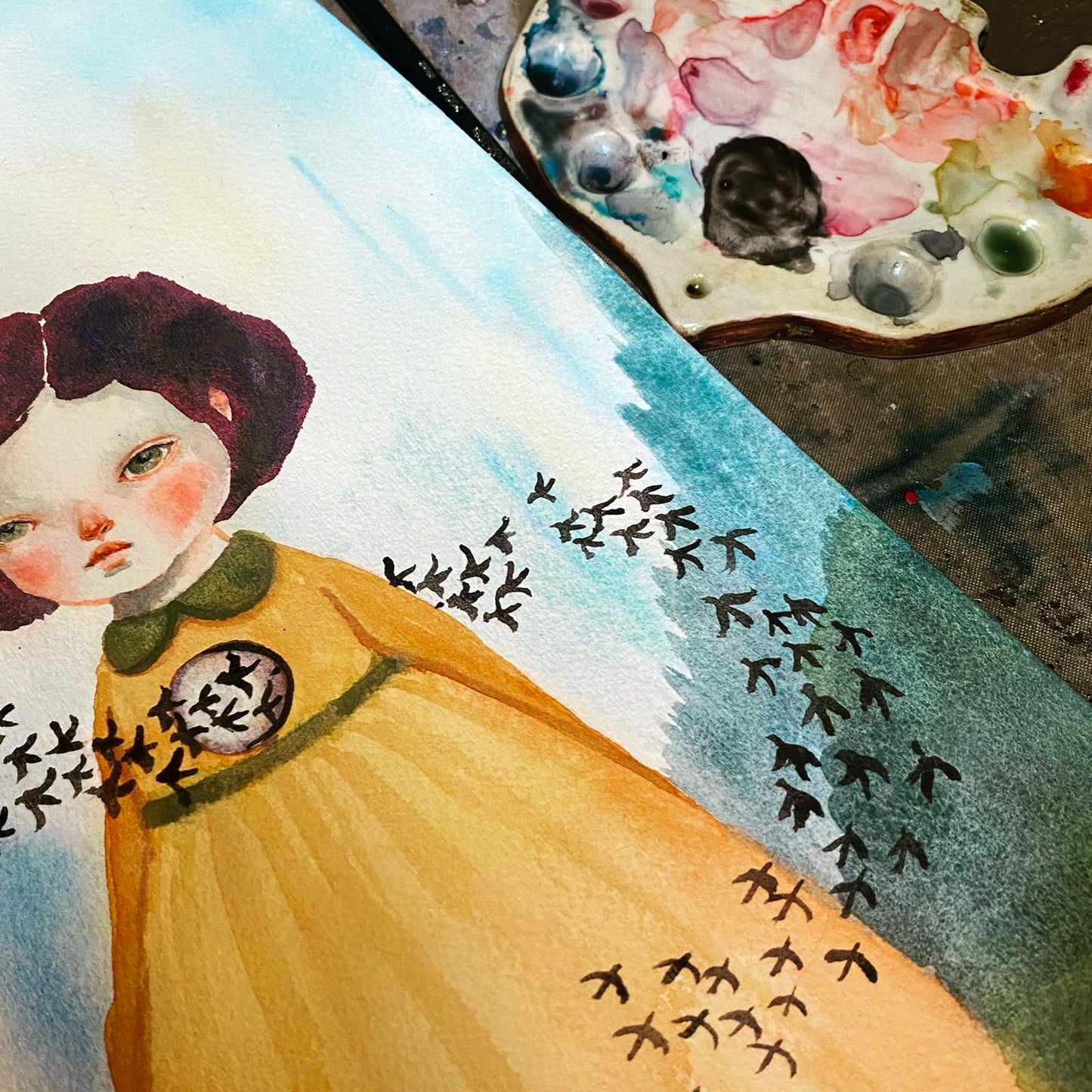 A beautiful original watercolor by Idania Salcido, the artist behind Danita Art.  A vintage looking girl in a yellow dress and a hole in her heart. Black birds go trough her and take her sorrows away.