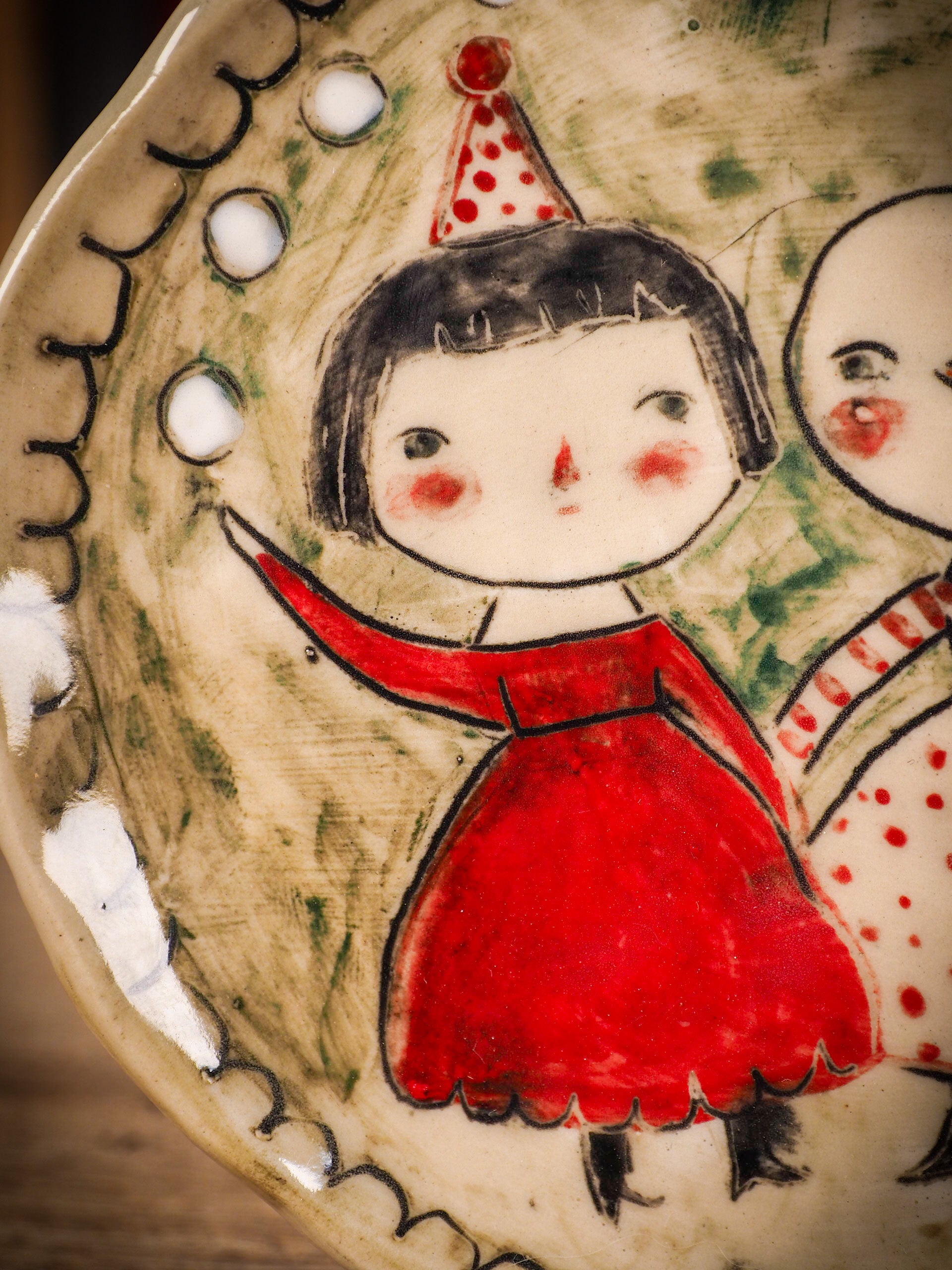 An original Christmas Holiday cake dinner plate round glazed ceramic dinnerware handmade by Idania Salcido, the artist behind Danita Art. Glazed carved sgraffito stoneware, hand painted and decorated, it is illustrated by hand with snowmen, Christmas trees, Santa Claus, angels and snow balls and winter themes.