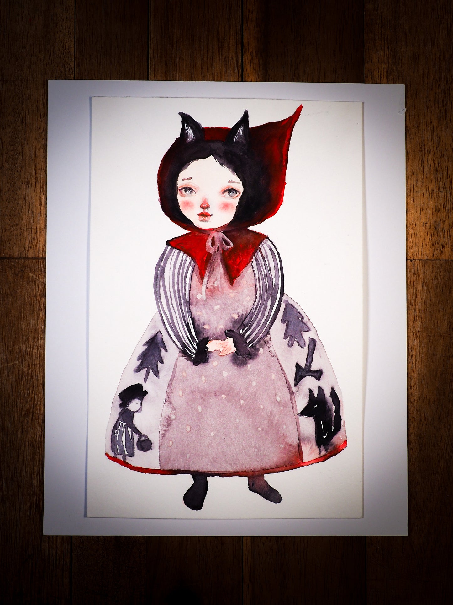 An original mixed media watercolor by Idania Salcido, the artist behind Danita Art.  This is a beautiful mixed media painting, iNapier’s by the story of Lit le Red Riding Hood. Painted with watercolors over watercolor paper.