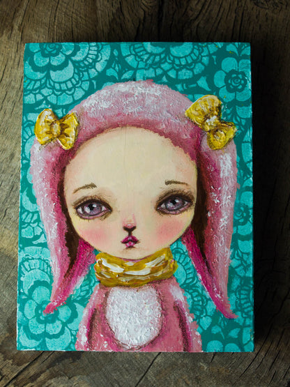 A pop surrealism self portrait of Danita as a pink, fluffy bunny in mixed media.