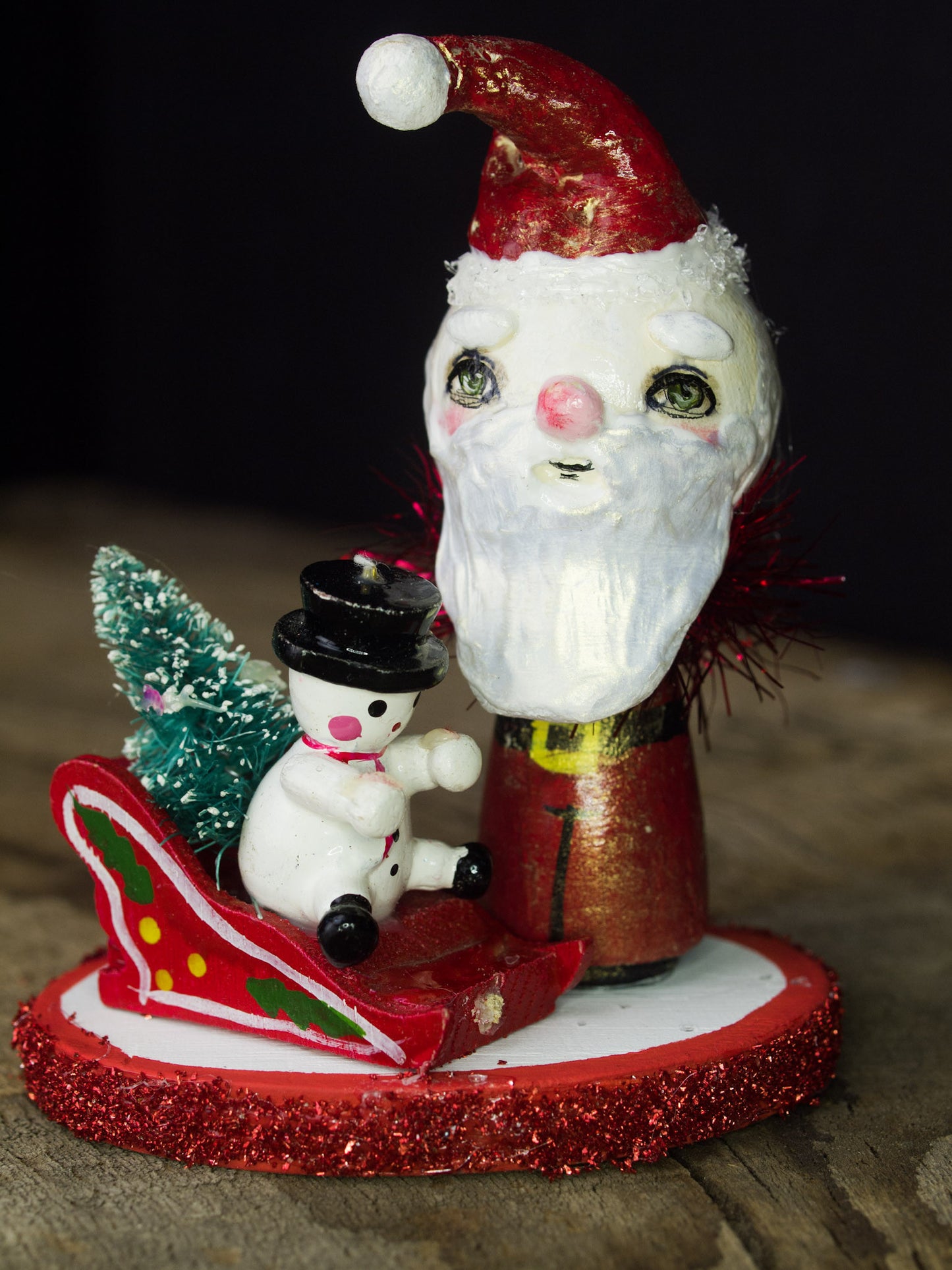 Santa in his magic sled, a holiday wood kokeshi art doll created by Danita Art