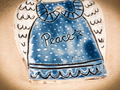 An original Christmas Holiday tree round glazed ceramic ornament handmade by Idania Salcido, the artist behind Danita Art. Glazed carved sgraffito stoneware, hand painted and decorated, it is illustrated by hand with winter scenes with snowmen, Christmas trees, Santa Claus, angels and snow balls and winter themes.