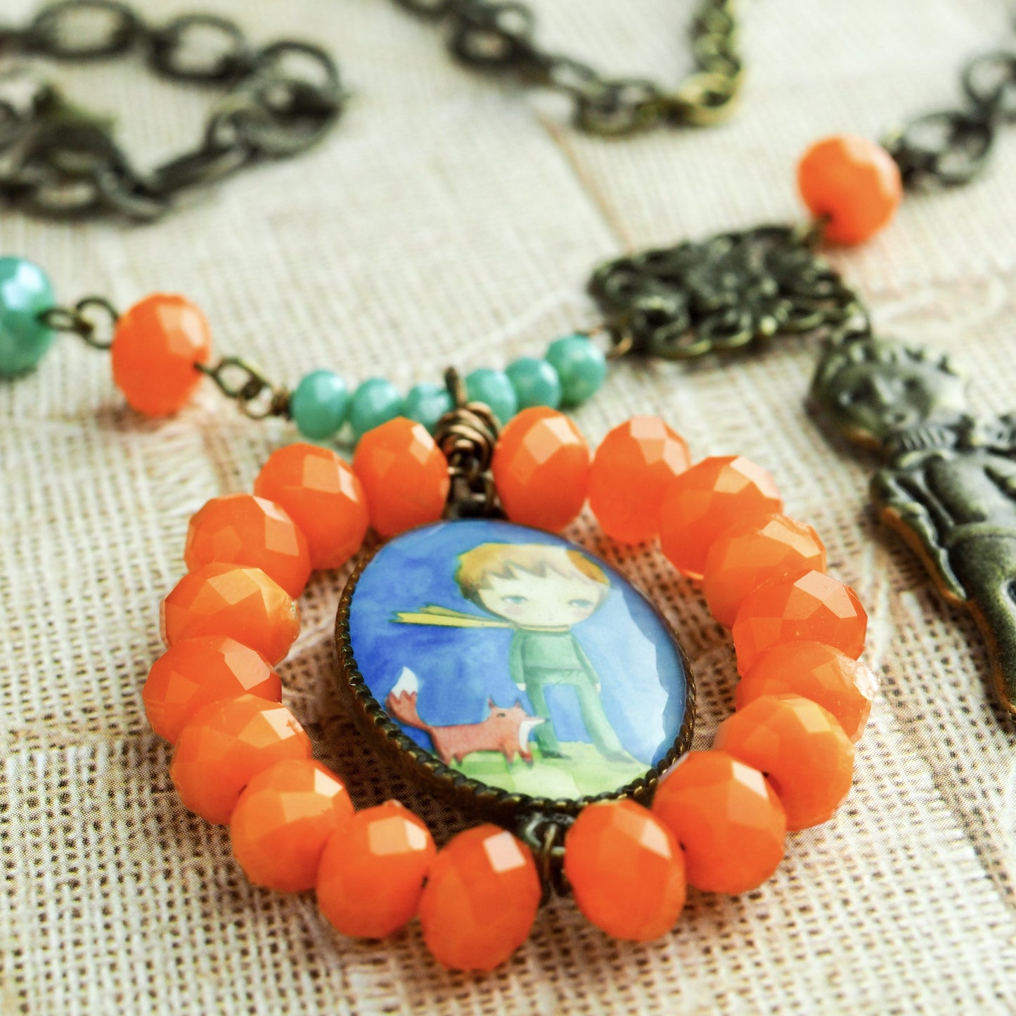 The little prince lives in this handcrafted necklace. Hand made by the talented mixed media artist, Danita.