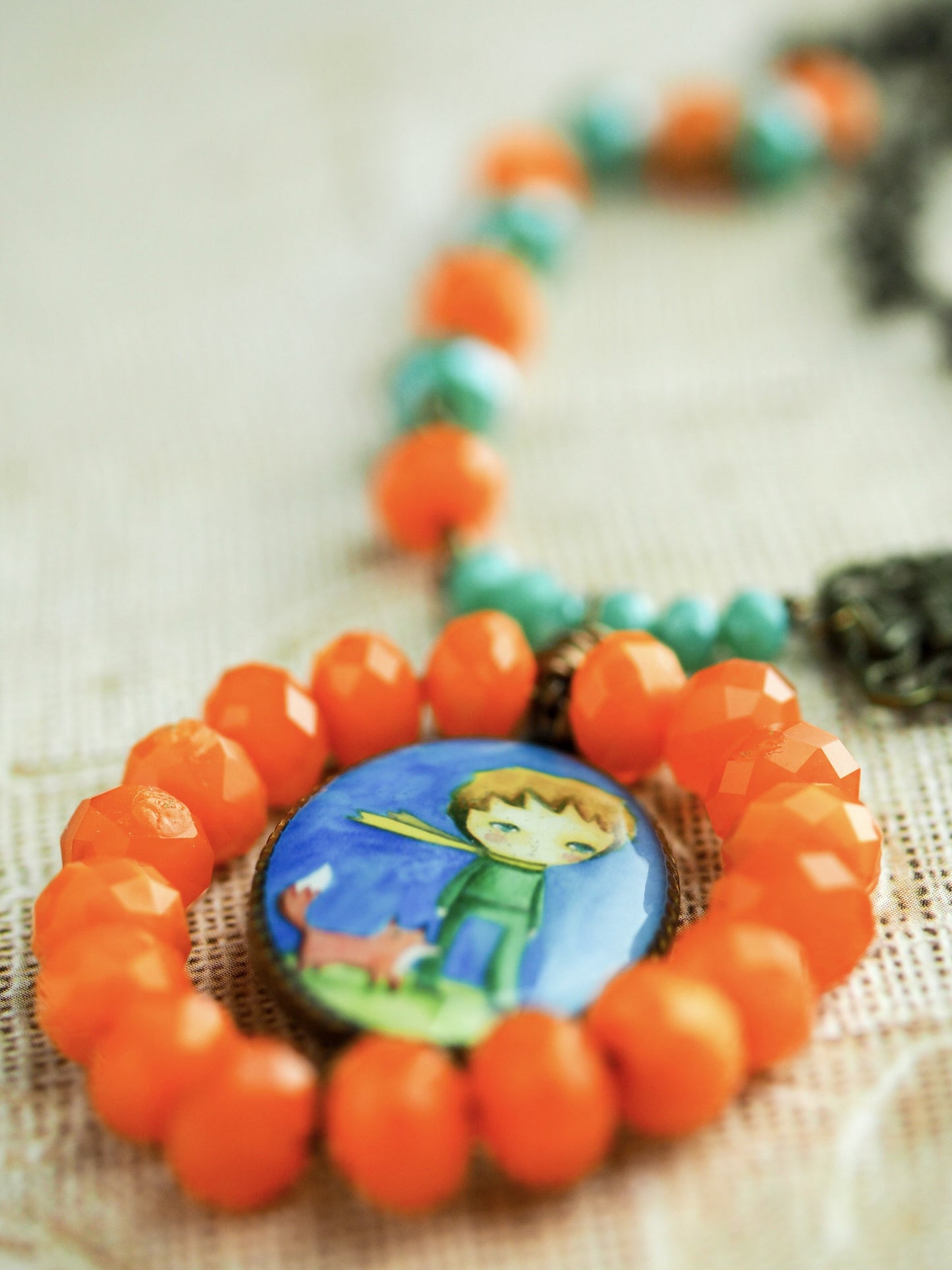 The little prince lives in this handcrafted necklace. Hand made by the talented mixed media artist, Danita.