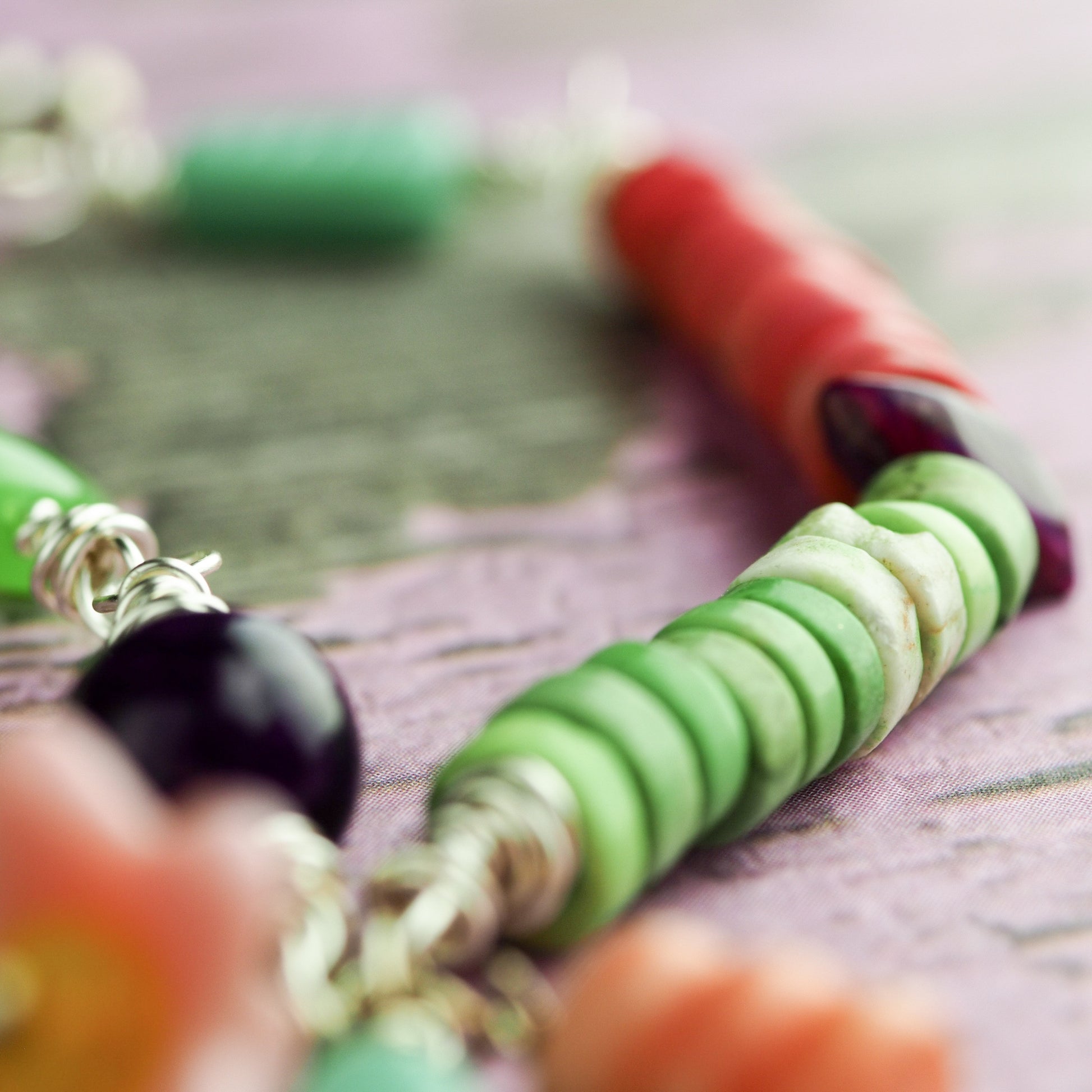 Two sisters enjoy the joy of baking in this original bracelet by Da its Art. Glass beads and jade make this colorful and beautiful piece of wearable art.