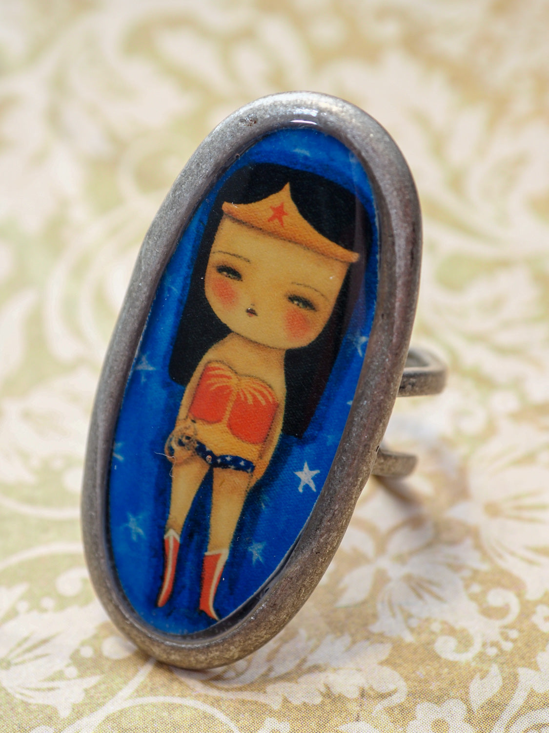 Wonder Woman empowers you with this amazing handmade ring made by Danita Art. It's the perfect accessory for any outfit for your own unique style.
