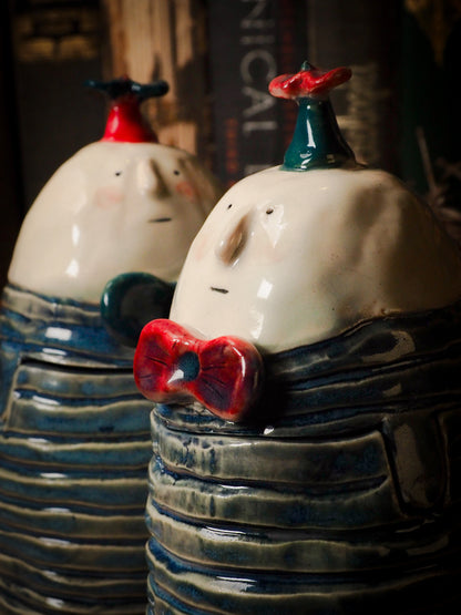Tweedle Dee and Tweedle Dum ceramic figure inspired by Alice in Wonderland made by Idania Salcido, the mixed media artist and ceramist behind Danita Art. Earth clay is hand sculpted and glazed and kiln fired to create a ceramic home decor heirloom figurine. Each unique art piece is a one of a kind fine pottery artwork.
