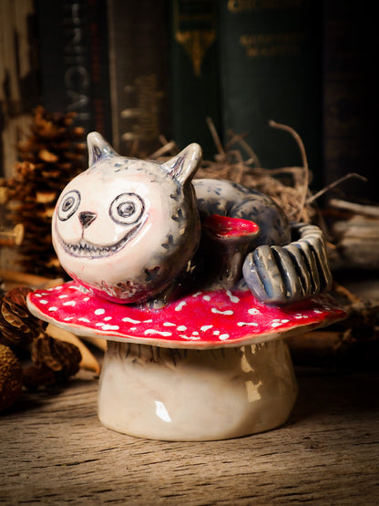 Cheshire Cat vintage pet ceramic figure inspired by Alice in Wonderland made by Idania Salcido, the mixed media artist and ceramist behind Danita Art. Earth clay is hand sculpted and glazed and kiln fired to create a ceramic home decor heirloom figurine. Each unique art piece is a one of a kind fine pottery artwork.