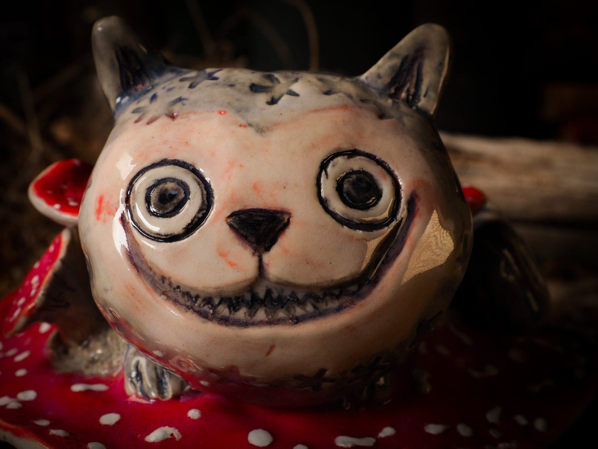 Cheshire Cat vintage pet ceramic figure inspired by Alice in Wonderland made by Idania Salcido, the mixed media artist and ceramist behind Danita Art. Earth clay is hand sculpted and glazed and kiln fired to create a ceramic home decor heirloom figurine. Each unique art piece is a one of a kind fine pottery artwork.