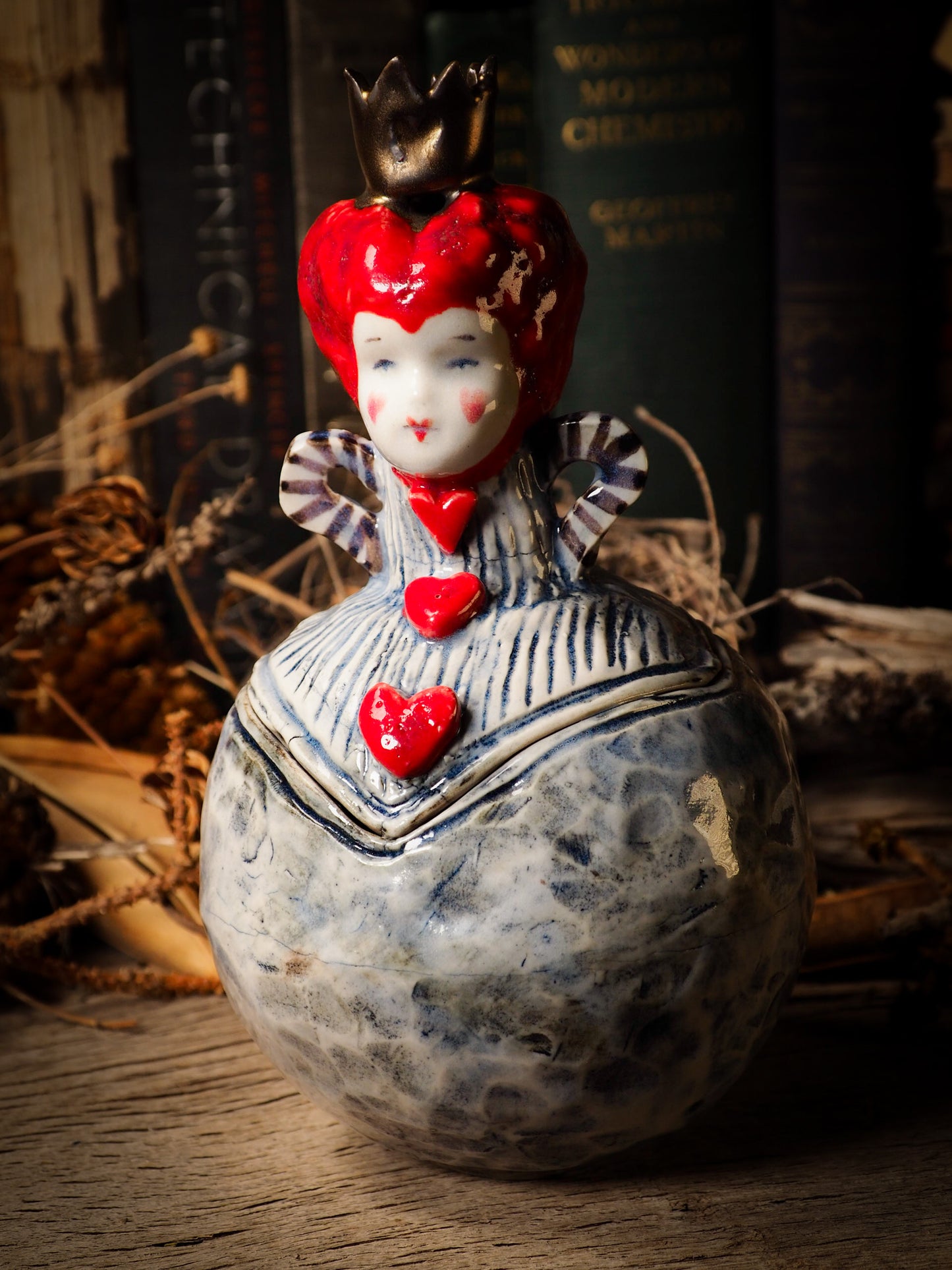 Red Queen hearts vintage ceramic figure inspired by Alice in Wonderland made by Idania Salcido, the mixed media artist and ceramist behind Danita Art. Earth clay is hand sculpted and glazed and kiln fired to create a ceramic home decor heirloom figurine. Each unique art piece is a one of a kind fine pottery artwork.
