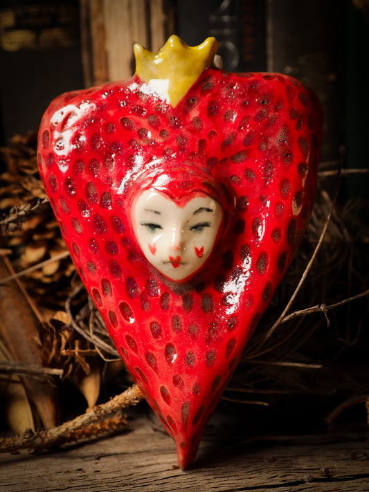 red burning heart glazed ceramic torso figure inspired by Alice in Wonderland by Idania Salcido, the artist behind Danita Art. Lumps of clay hand sculpted and glazed are kiln fired. Beautiful heart shaped wall hangings with nail hole in the back to place on wall with a hook or display on shelf or showcase.