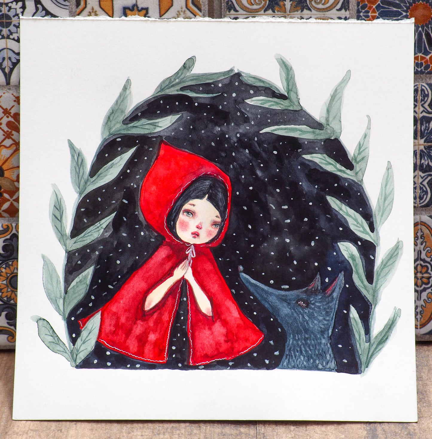 Danita loves painting Little Red riding Hood and the Wolf. This time, it's a 8 x 8 watercolor original, where I painted the wold in gray and silver paint and Little Red Riding Hood is wearing a bright red cape with intricate watercolor shades and silverly thread details on her cape.