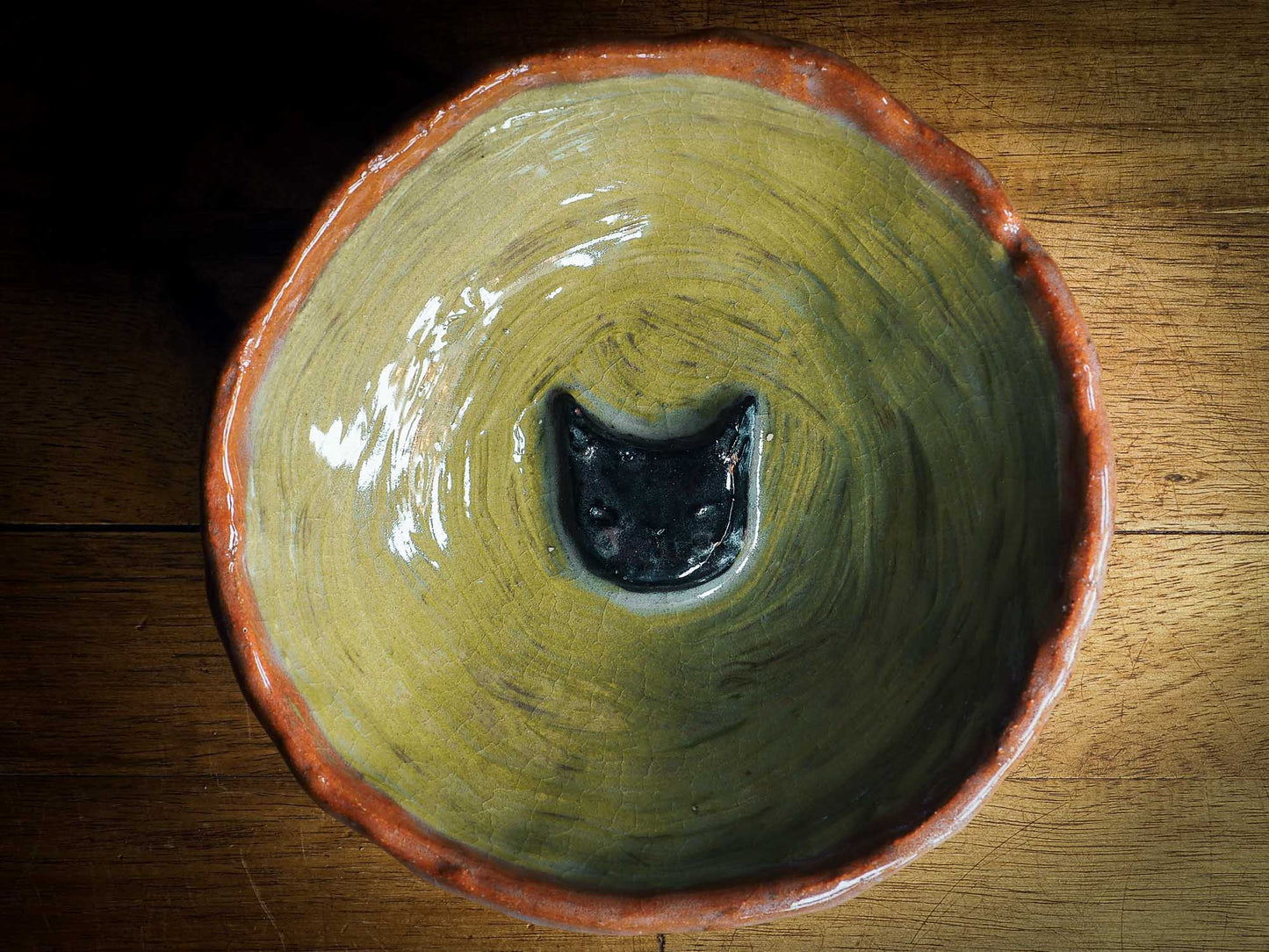 An original Idania Salcido Danita Art pinched ceramic white cat pet food bowl. Handmade from locally foraged clay, this glazed ceramics one of a kind artwork is perfect for any kitchen plate and bowls unique collection. A hand made black cat waits for you at the bottom of this brown and green striped pet food bowl.