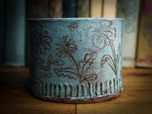 An original Idania Salcido Danita Art pinched ceramic cat pet food bowl. Handmade from locally foraged clay, this glazed ceramics one of a kind artwork is perfect for any kitchen plate and bowls unique collection. Thumbprints and  intentionally irregular shape give the bowl a cozy, warmly familiar feel when you pick it. It has a blue bird and flowers carved on the sides of this beautiful vase or bowl.