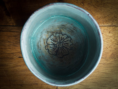 An original Idania Salcido Danita Art pinched ceramic cat pet food bowl. Handmade from locally foraged clay, this glazed ceramics one of a kind artwork is perfect for any kitchen plate and bowls unique collection. Thumbprints and  intentionally irregular shape give the bowl a cozy, warmly familiar feel when you pick it. It has a blue bird and flowers carved on the sides of this beautiful vase or bowl.