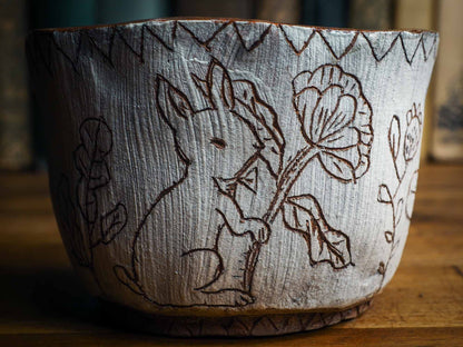 An original Idania Salcido Danita Art pinched ceramic cat pet food bowl. Handmade from locally foraged clay, this glazed ceramics one of a kind artwork is perfect for any kitchen plate and bowls unique collection. Thumbprints and  intentionally irregular shape give the bowl a cozy, warmly familiar feel when you pick it. A cute little white rabbit is carved on the sides.