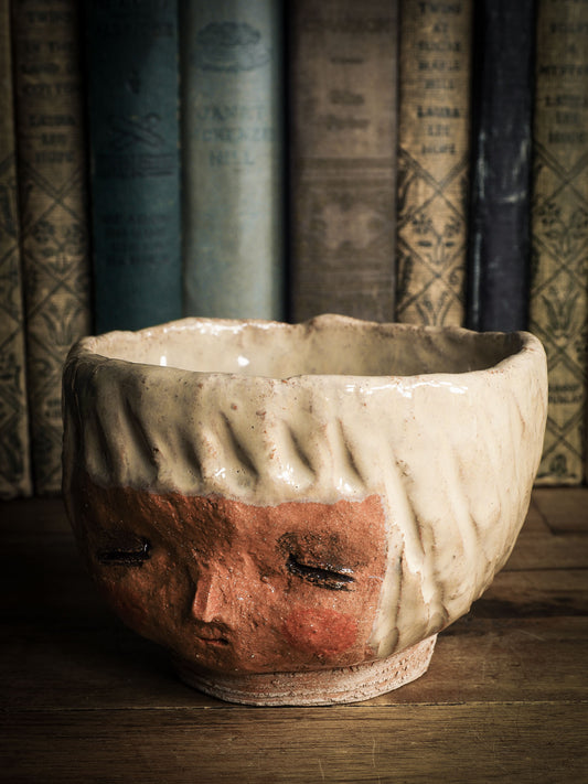 An original Idania Salcido Danita Art pinched ceramic cat pet food bowl. Handmade from locally foraged clay, this glazed ceramics one of a kind artwork is perfect for any kitchen plate and bowls unique collection. Thumbprints and  intentionally irregular shape give the bowl a cozy, warmly familiar feel when you pick it. An adorable face like the ones Danita paints and makes dolls with is featured!