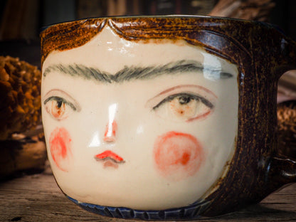 An original Frida Kahlo inspired fire glazed ceramic handmade piece by Idania Salcido, the artist behind Danita Art. Glazed, carved sgraffito stoneware, hand painted and decorated, it is illustrated by hand with the face and iconic unibrow ofFrida Kahlo, in a new artistic interpretation on the style of Danita Art.