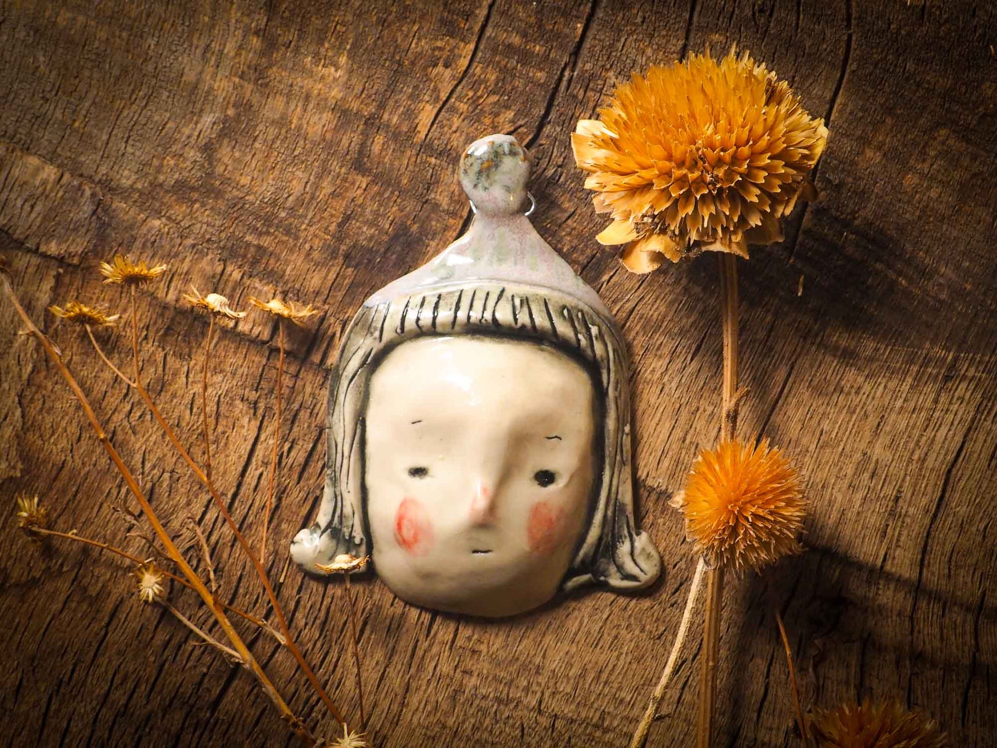 You are looking at an original handmade ceramic hanging face figurine by Idania Salcido, the artist behind Danita Art. Each one is a unique work of art on itself, designed and hand built by me, Idania Salcido. It will add a beautiful handmade touch to any artist's studio, and it's cute details will let your inspiration flow freely. 