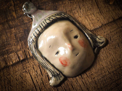 You are looking at an original handmade ceramic hanging face figurine by Idania Salcido, the artist behind Danita Art. Each one is a unique work of art on itself, designed and hand built by me, Idania Salcido. It will add a beautiful handmade touch to any artist's studio, and it's cute details will let your inspiration flow freely. 