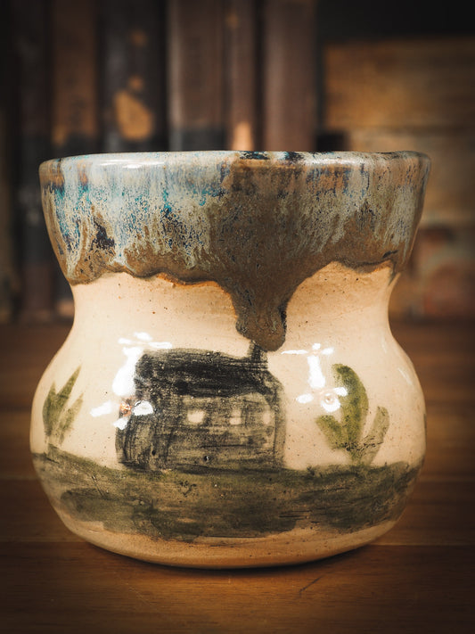 An original Idania Salcido Danita Art pinched ceramic cat pet food plate. Handmade from stoneware, this glazed ceramics one of a kind artwork is perfect for any kitchen plate and bowls unique collection. Thumbprints and  intentionally irregular shape give the bowl a cozy, warmly familiar feel when you pick it. A cute little black cat and a home is painted in underglaze.