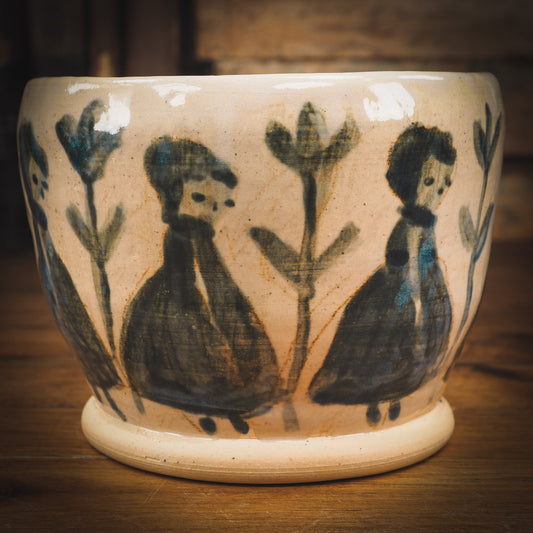 An original Idania Salcido Danita Art pinched ceramic cat pet food plate. Handmade from stoneware, this glazed ceramics one of a kind artwork is perfect for any kitchen plate and bowls unique collection. Thumbprints and  intentionally irregular shape give the bowl a cozy, warmly familiar feel when you pick it. Flowers and girls painted in underglaze make this a beautiful unique piece.