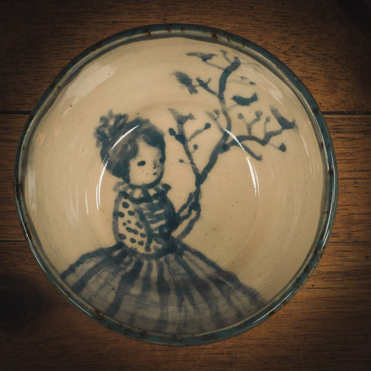 An original Idania Salcido Danita Art ceramic cat pet food plate. Handmade from stoneware, this glazed ceramics one of a kind artwork is perfect for any kitchen plate and bowls unique collection. Thumbprints and  intentionally irregular shape give the bowl a cozy, warmly familiar feel when you pick it. Birds in a tree and a beautiful girl painted in blue underglaze make this a beautiful unique piece.