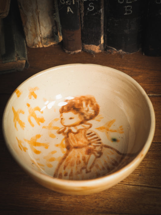 An original Idania Salcido Danita Art ceramic cat pet food plate. Handmade from stoneware, this glazed ceramics one of a kind artwork is perfect for any kitchen plate and bowls unique collection. Thumbprints and  intentionally irregular shape give the bowl a cozy, warmly familiar feel when you pick it. A flock of yellow birds greets a beautiful girl in a striped dress, painted in watercolor style underglaze by Danita Art.