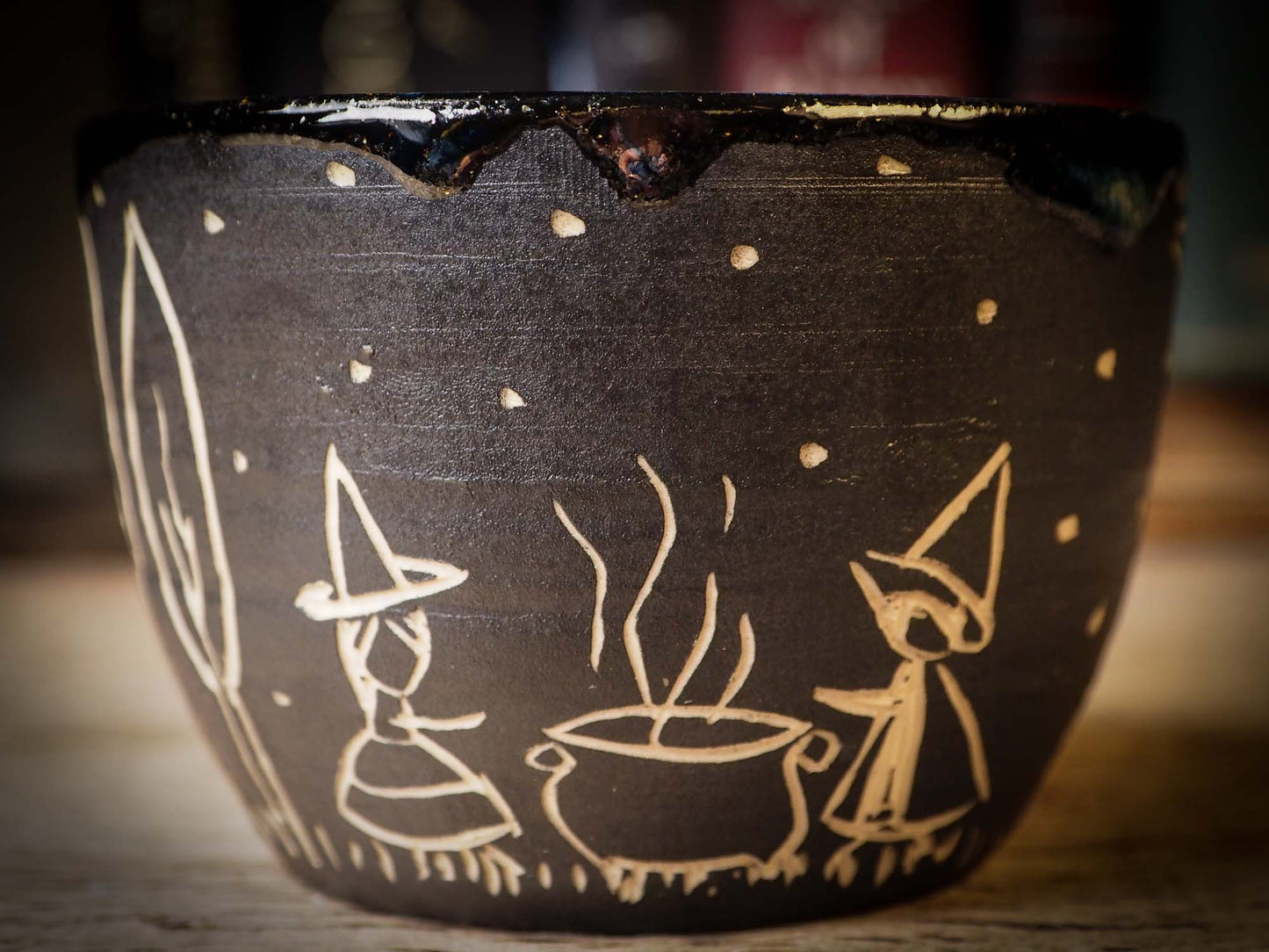 An original Halloween ceramic tumbler bowl by Idania Salcido, the artist behind Danita Art. Made with wheel thrown clay, hand carved and glazed by the artist. The carved witches, ghosts, goblins and vampires give it a nice, folk art primitive feel to it. Perfect for Halloween Candy, ice cream and fruit, a pet cat bowl.
