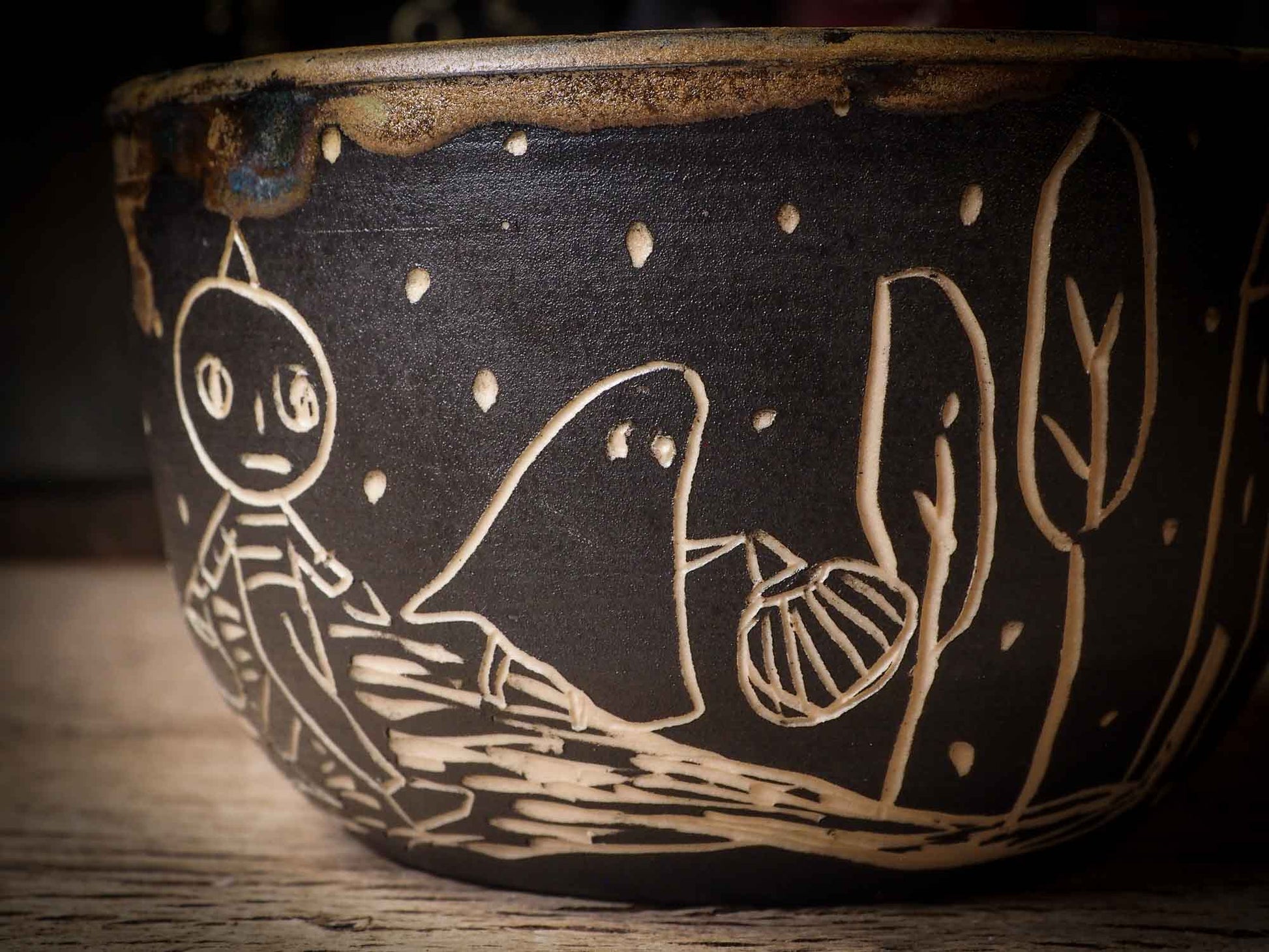 An original Halloween ceramic tumbler bowl by Idania Salcido, the artist behind Danita Art. Made with wheel thrown clay, hand carved and glazed by the artist. The carved witches, ghosts, goblins and vampires give it a nice, folk art primitive feel to it. Perfect for Halloween Candy, ice cream and fruit, a pet cat bowl.
