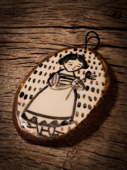 Unique fired ceramic porcelain necklace oval pendant by Idania Salcido, the artist behind Danita Art. Each jewelry setting is hand drawn and illustrated by the artist in her art studio, perfect for any dressing style. A casual gathering with friends or a fancy formal dinner, this necklace is a perfect fashion accessory.