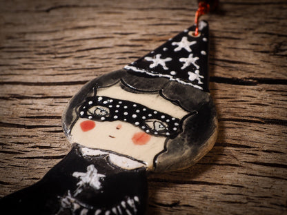 An original handmade Halloween ornament by Idania Salcido, Danita Art. Each ornament is hand carved with pumpkins, witches, cats, jack-o-lanterns and moons.  Made with fired glazed ceramics, this little witch, jack-o-lantern and cat is carved with delicate patterns that make each ornament a one of a kind work of art.