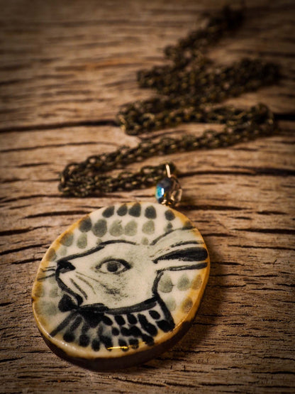 Unique fired ceramic porcelain necklace oval pendant by Idania Salcido, the artist behind Danita Art. Each jewelry setting is hand drawn and illustrated by the artist in her art studio, perfect for any dressing style. A casual gathering with friends or a fancy formal dinner, this necklace is a perfect fashion accessory.
