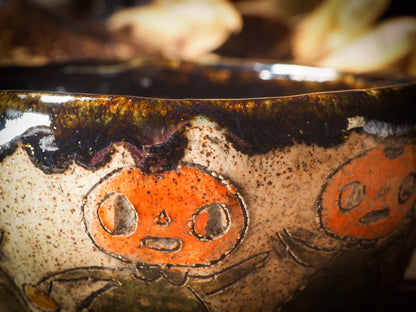 Fire glazed ceramic coffee mug by Idania Salcido, Danita Art. On Halloween, Danita creates ceramic containers for pumpkin spice coffee, warm tea or sweets to give on trick-or-treat night. With carved with Halloween ghosts, skeletons, witches, ghouls, black cats, jack-o-lanterns, item is food safe, hand wash only.