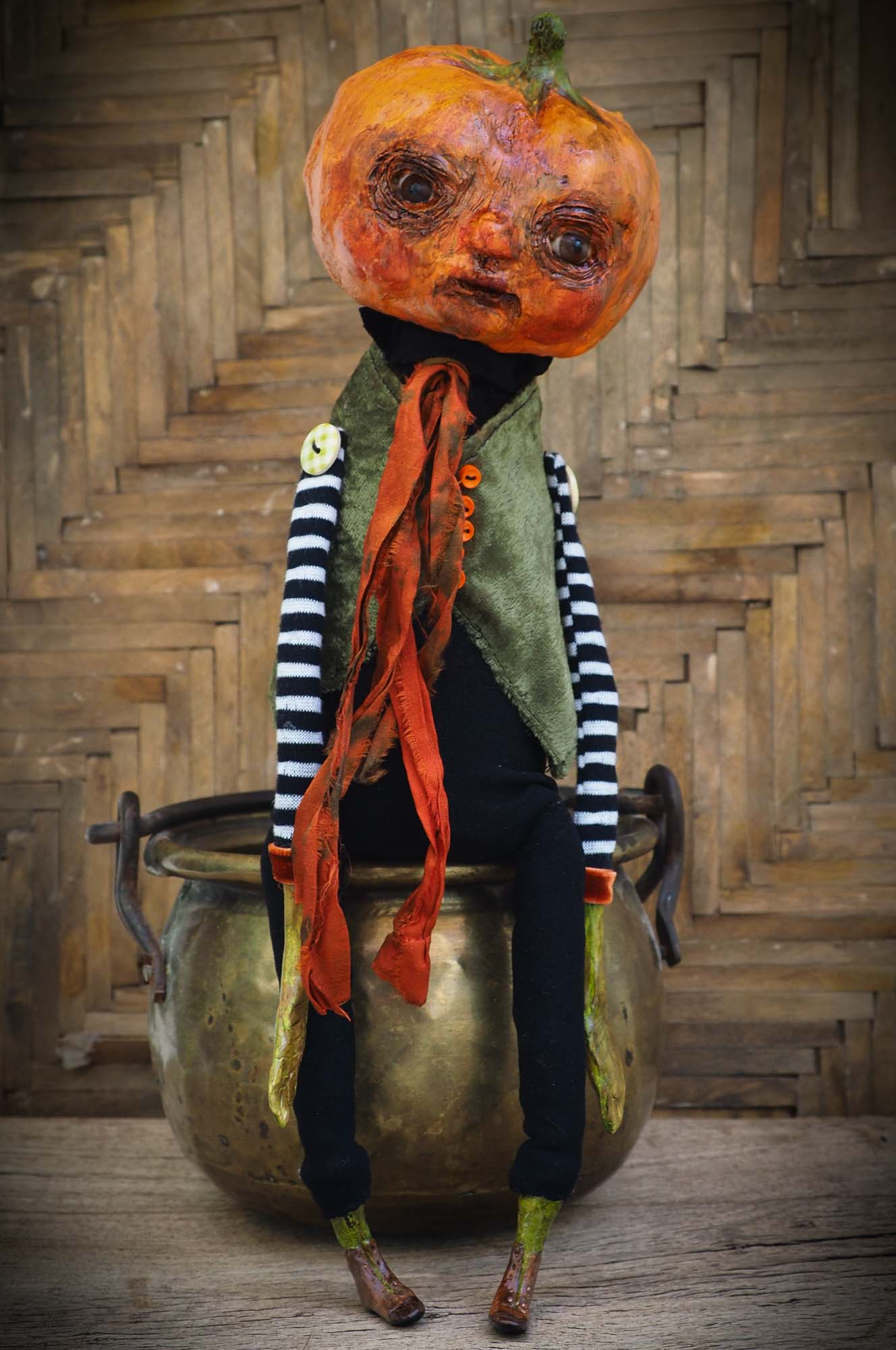 A witch transformed a boy into a Halloween pumpkin monster. This Danita original doll is a handmade jack-o-lantern soft sculpture as home decoration ornament. Carefully handmade with whimsical folk art roots, the spooky ghosts, witches, vampires, ghouls, and jack-o-lantern art dolls of Danita are full of mystery lore.