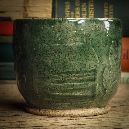 An original glazed ceramic jar by Idania Salcido, the artist behind Danita Art. It measures 3 x 3 x 3.5 Inches, with deep green hue glazes and hand decorated figures on the sides. Totally handmade in my studio, this is a unique piece that cannot be repeated. Food and drink safe, hand wash only.