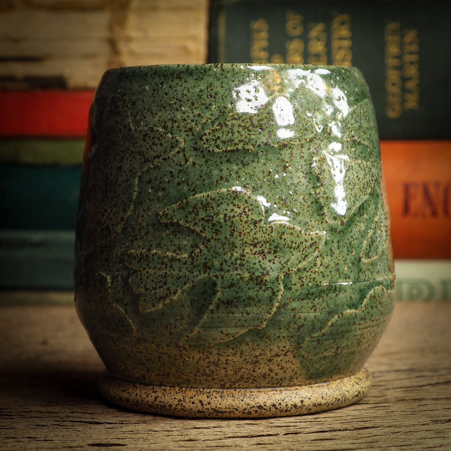 An original glazed ceramic jar by Idania Salcido, the artist behind Danita Art. It measures 2.5 x 2.5 x 3.5 Inches, with deep green hue glazes and hand decorated figures on the sides. Totally handmade in my studio, this is a unique piece that cannot be repeated. Food and drink safe, hand wash only.