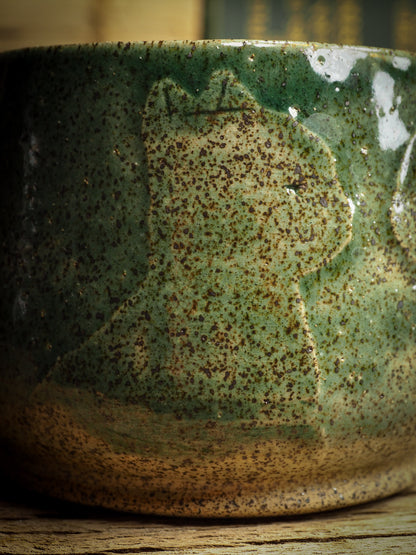 An original glazed ceramic jar by Idania Salcido, the artist behind Danita Art. It measures 3 x 3 x 3 Inches, with deep green hue glazes and hand decorated figures on the sides. Totally handmade in my studio, this is a unique piece that cannot be repeated. Food and drink safe, hand wash only.