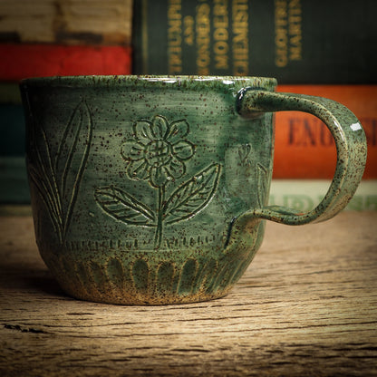 An original glazed ceramic mug by Idania Salcido, the artist behind Danita Art. It measures 3 x 3 x 3 Inches, with deep green hue glazes and hand decorated figures on the sides. Totally handmade in my studio, this is a unique piece that cannot be repeated. Food and drink safe, hand wash only.