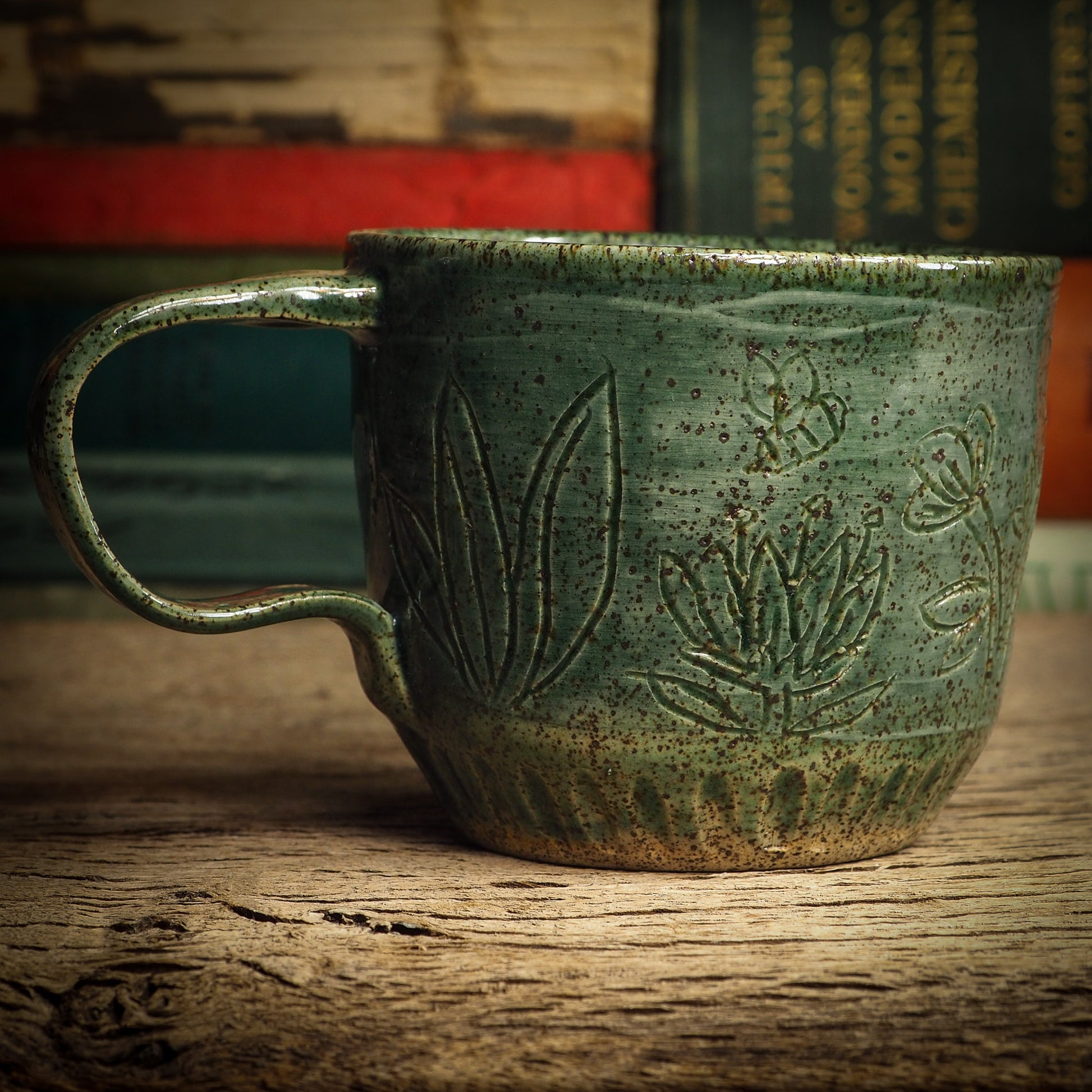 An original glazed ceramic mug by Idania Salcido, the artist behind Danita Art. It measures 3 x 3 x 3 Inches, with deep green hue glazes and hand decorated figures on the sides. Totally handmade in my studio, this is a unique piece that cannot be repeated. Food and drink safe, hand wash only.
